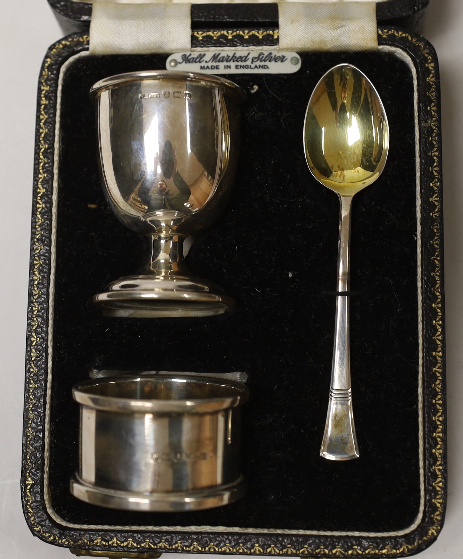 A cased George VI silver christening egg cup, spoon and napkin ring, Birmingham, 1946/7.